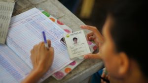 Around the world, blockchain technology helps displaced people regain IDs and access to other social services. Here, a CARD agent in the Philippines tracks IDs by hand. Photo credit: Brooke Patterson/USAID.