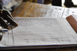 Unlike hand-written records, like this bed net distribution in Tanzania, data added to a blockchain can’t be erased or manipulated. Photo credit: USAID.