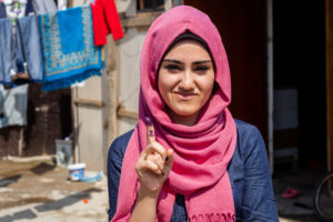 Young Iraq woman pictured at the Harsham IDP camp in Erbil, Iraq. Digital IDs and biometrics have potential to facilitate the voting process. Photo credit: Jim Huylebroek for Creative Associates International.